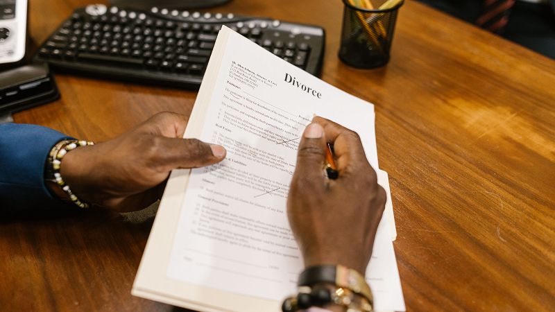A fountain pen resting on a printed legal document on a desk.