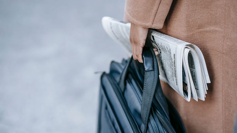 A professional carrying a document bag on the way to an appointment.